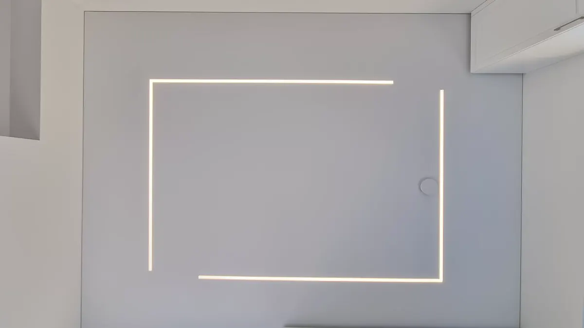 The same room after installation — a recessed light line around the full ceiling perimeter