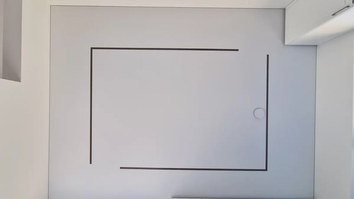 The room before installation — ceiling plane without a recessed light line