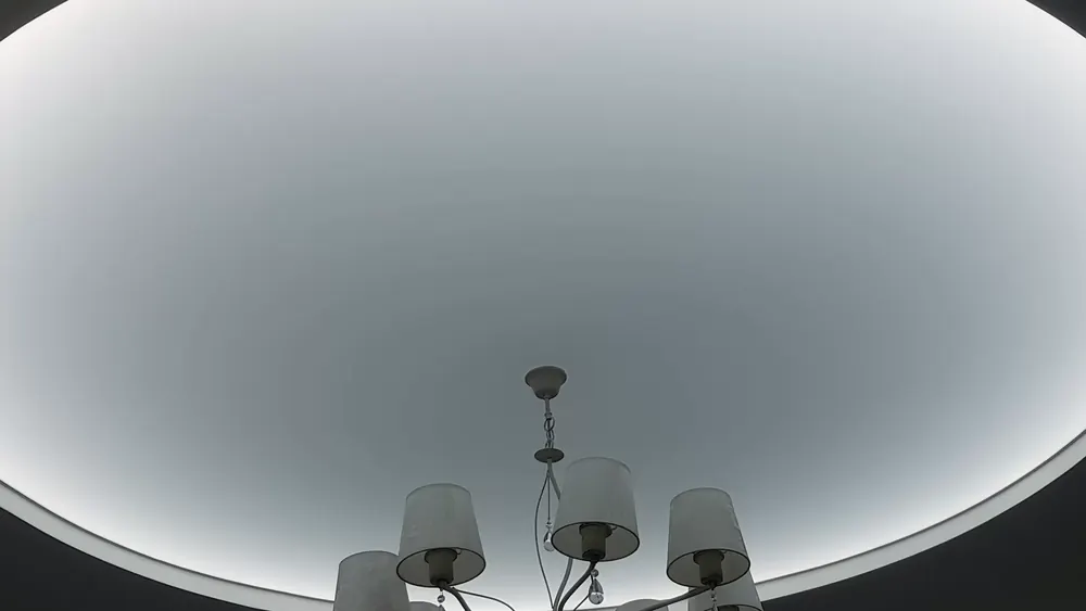 Round illuminated stretch ceiling plane — a whole section of ceiling as the light source