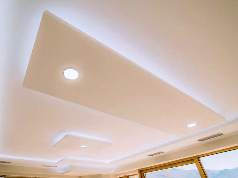 Two-level stretch ceiling with concealed lighting